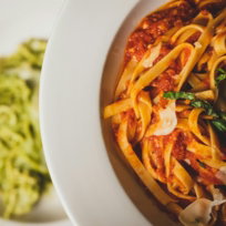 a-plate-of-pasta-with-sauce-and-spinach-on-the-side.jpg a plate of pasta with sauce and spinach on the side